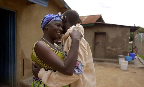 Ebola survivor Justin Singo Nguma embraces his family after recovering from the disease.